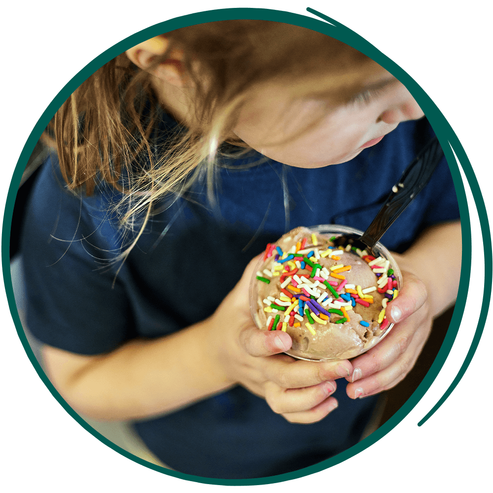 SMC-Website-Re-Skin-karens-kountry-store-7-25 young girl holding an ice cream with sprinkles