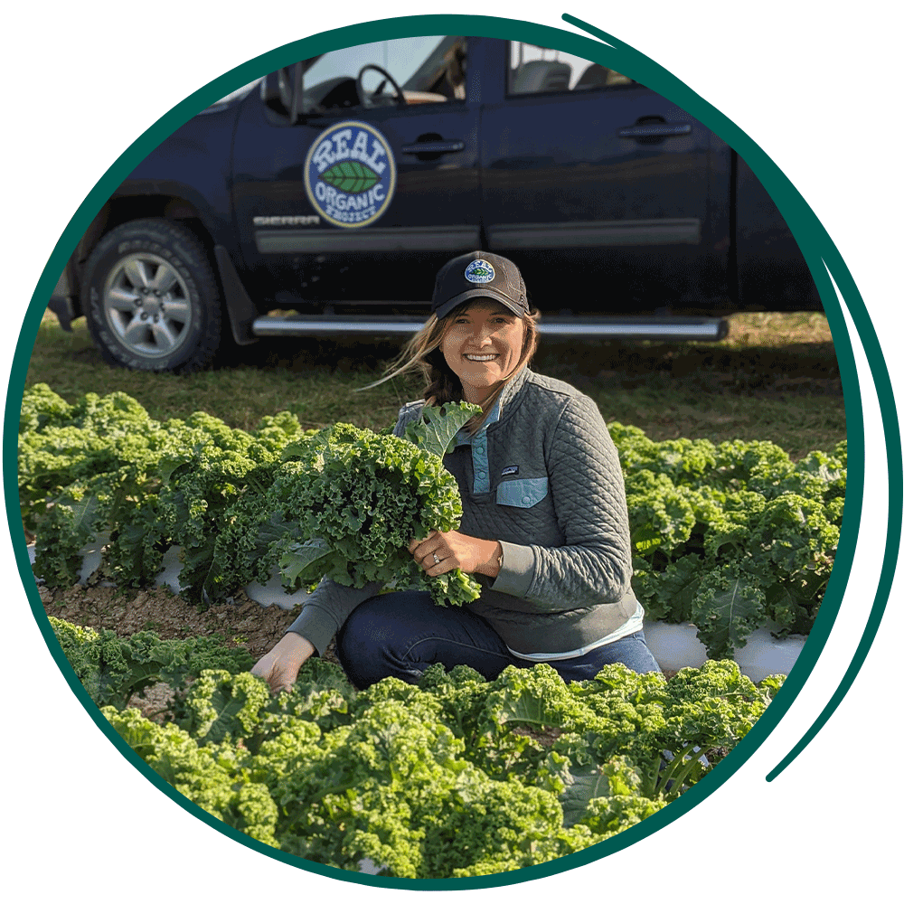 Young woman picking produce outside.